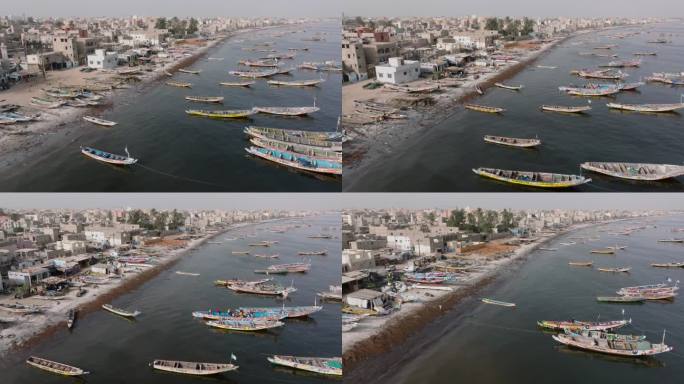空中飞行。色彩斑斓的独木舟停泊在被污染的塞内加尔河上。塞内加尔圣路易，联合国教科文组织世界遗产地，塑