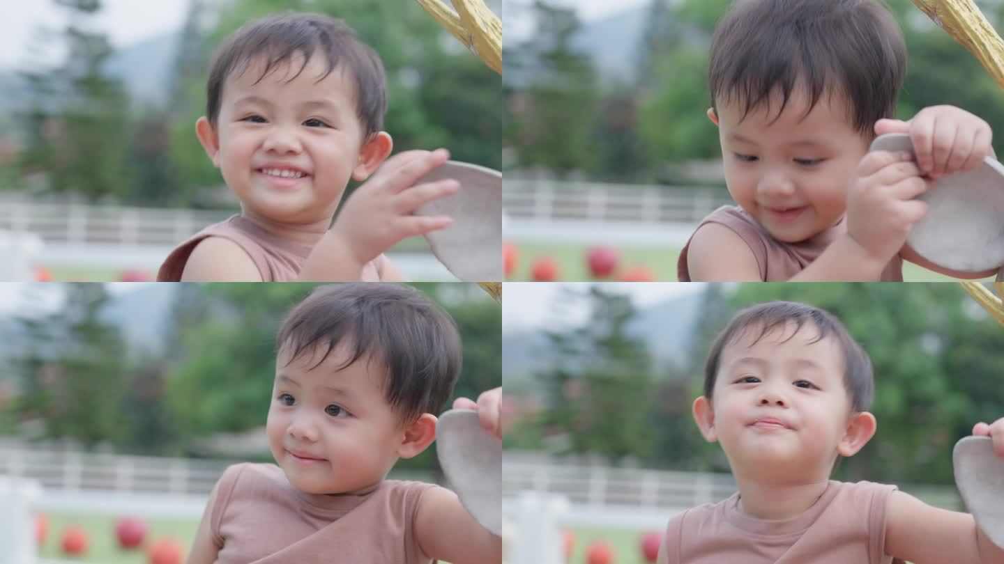 一个可爱的亚洲小男孩的特写脸在公园外面玩耍。面部表情和眼神探索。天真可爱的小婴儿。