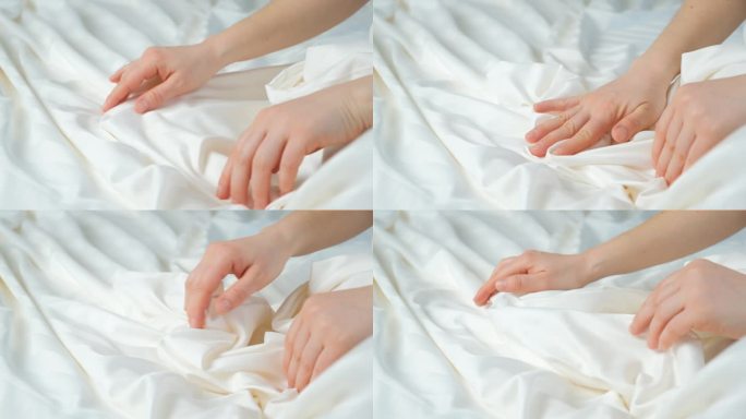 女人用手抚摸着条纹缎的织物，轻轻地抚摸着，特写。