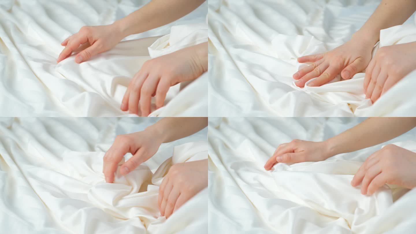 女人用手抚摸着条纹缎的织物，轻轻地抚摸着，特写。