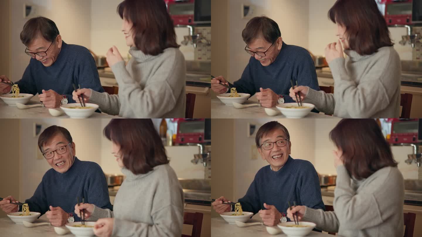 老两口，在家用筷子吃着面，聊着饭，开心地吃着营养。在东京，退休的日本女人、男人和食物用微笑、交谈和健