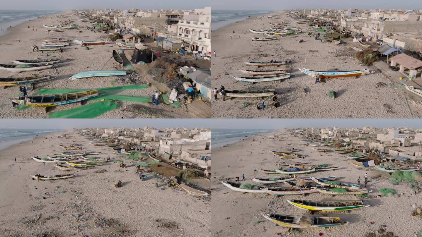 空中飞行。在塞内加尔的圣路易，五颜六色的皮划艇、令人震惊的塑料污染和垃圾躺在海洋的边缘