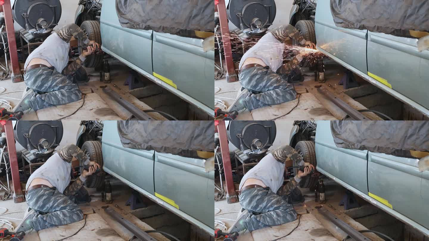 机械师用磨床除去汽车上的锈。