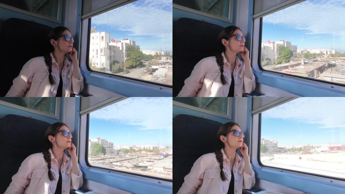 一位戴着墨镜的孤独的旅行者，从火车的窗口平静地望向窗外，欣赏着城市的风景。