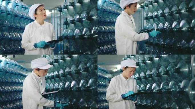 专业亚洲女性装瓶厂数码片质量控制检验员。瓶装水生产中的HACCP体系
