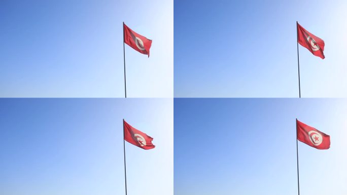突尼斯国旗在湛蓝的天空下飘扬，强调民族自豪感