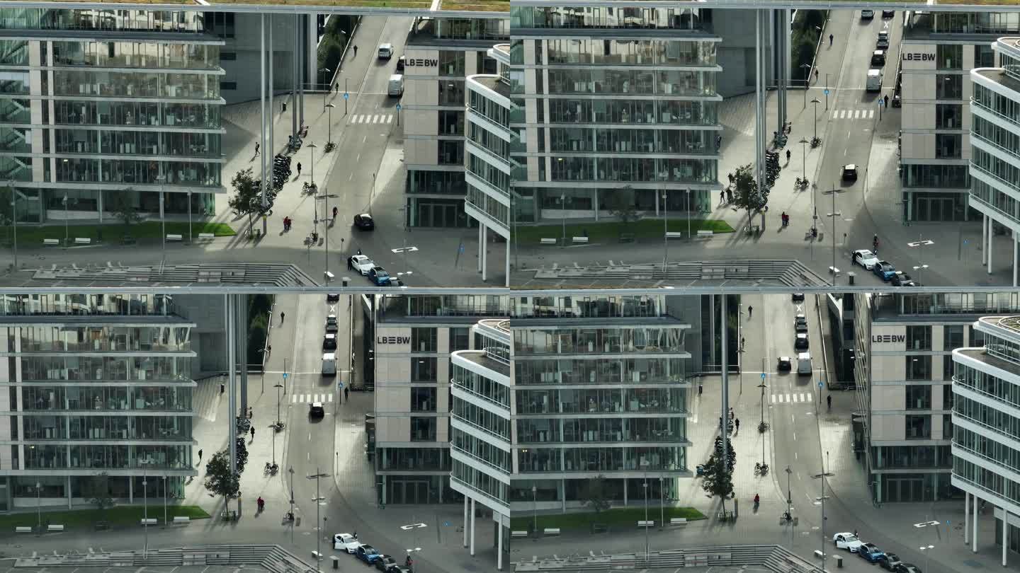 白天斯图加特市现代办公楼外部摩托停车场前街道广场航拍全景4k德国