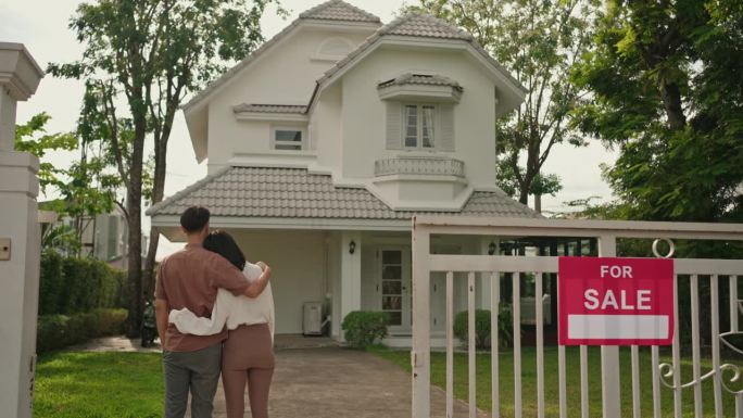 Couple in front of new house