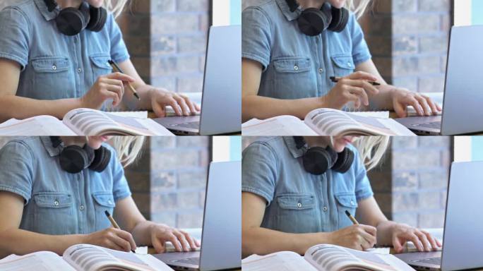 学生坐在书桌前，拿着笔记本电脑，在纸上做笔记。做笔记是学习过程中的一种常见做法，可以让学生突出重点，