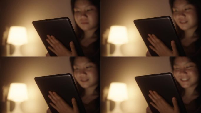 女孩在平板电脑上阅读电子书。