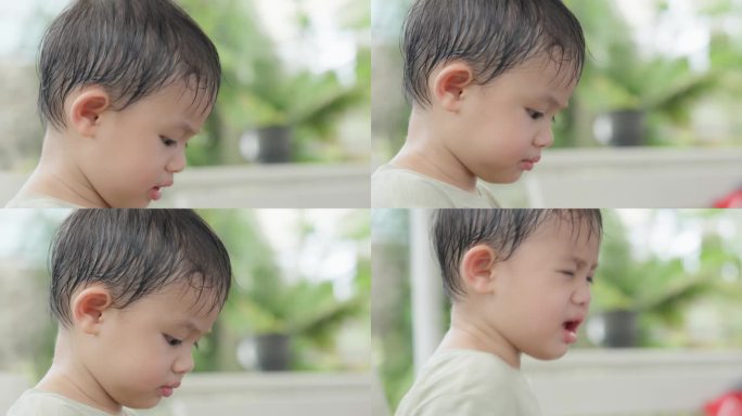 可爱的亚洲小男孩的特写脸在公园户外玩耍。面部表情和眼神探索。天真可爱的小婴儿。