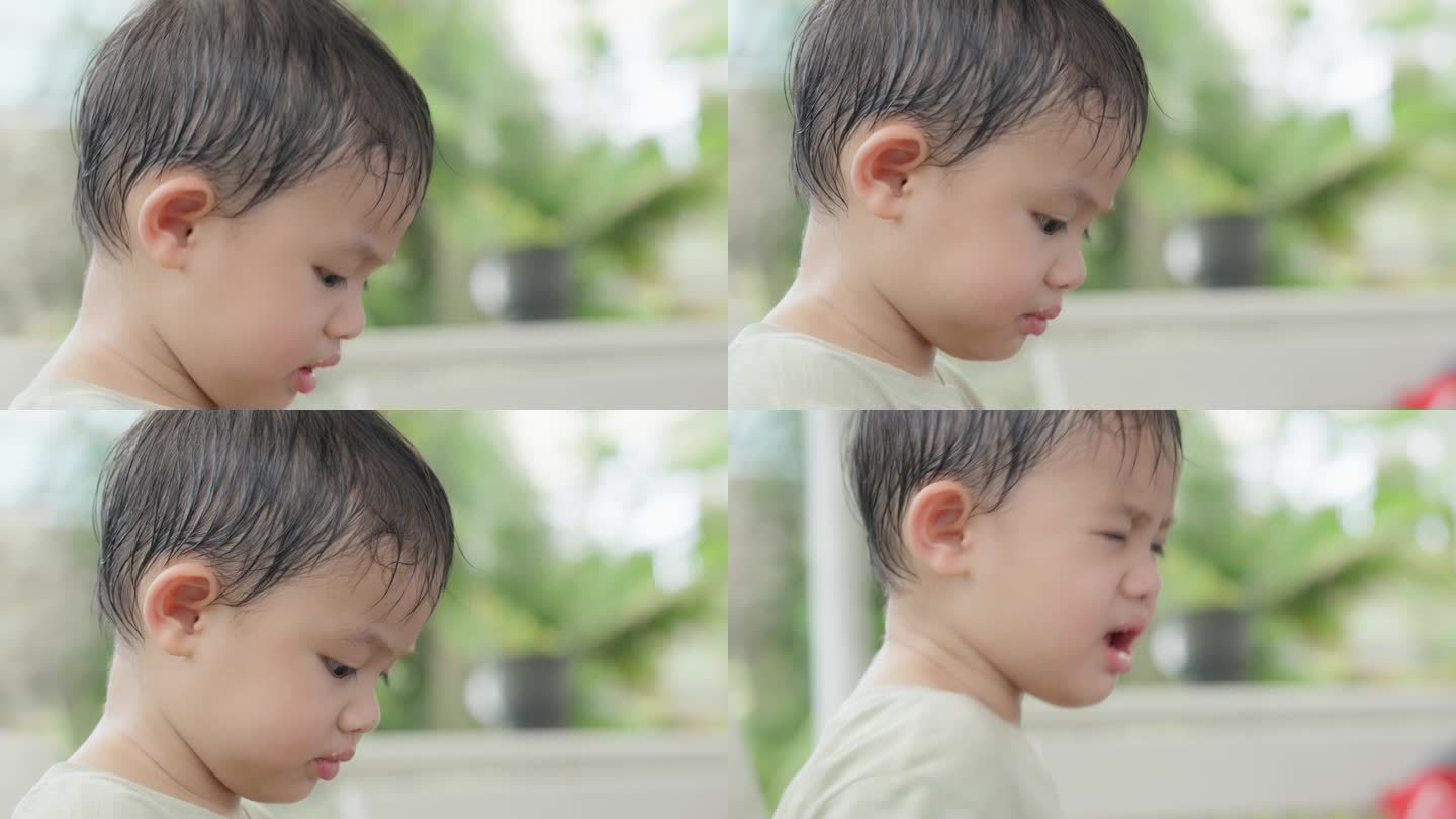 可爱的亚洲小男孩的特写脸在公园户外玩耍。面部表情和眼神探索。天真可爱的小婴儿。