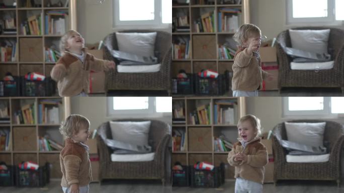 一个快乐的小男孩在家玩泡泡的慢镜头