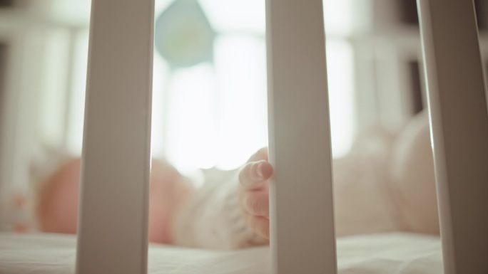 天真的探索:6个月大的婴儿床，沐浴在阳光和柔和的镜头光晕上