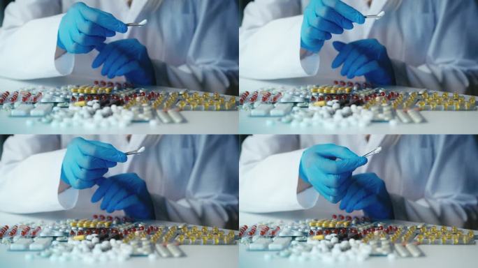 实验室工作人员检查白色胶囊，控制所生产药物的质量
