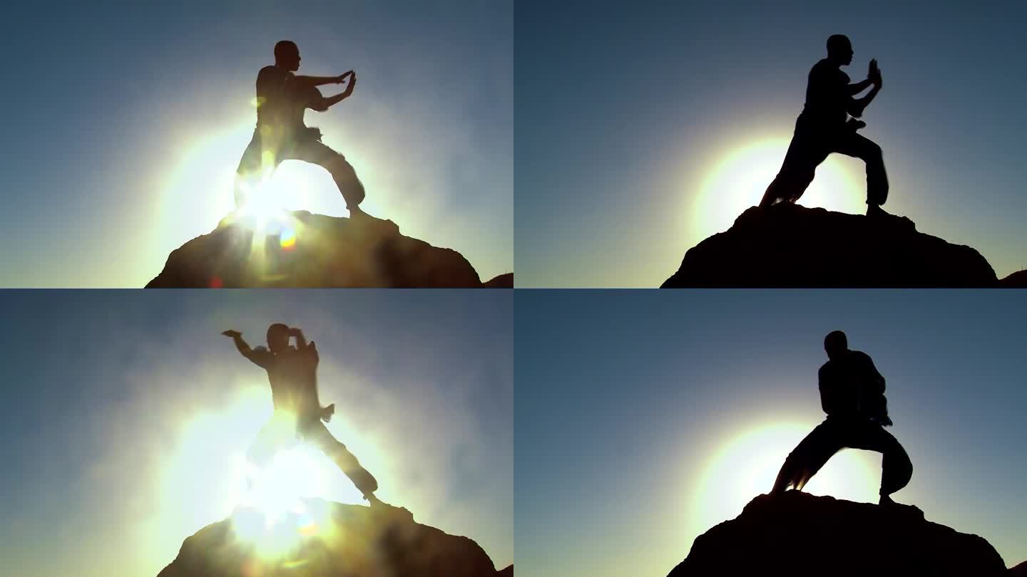 一个非洲裔美国人在一块高大的岩石上练习功夫的剪影，日落的黄金时间，太阳和耀斑在背景中的反射
