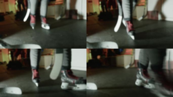 穿着溜冰鞋的冰球运动员在更衣室的橡胶保护垫上走向冰场。更衣室室内。运动员在寄存处换衣服。关闭了。模糊