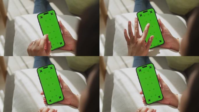 在家使用和观看智能手机绿屏的女性