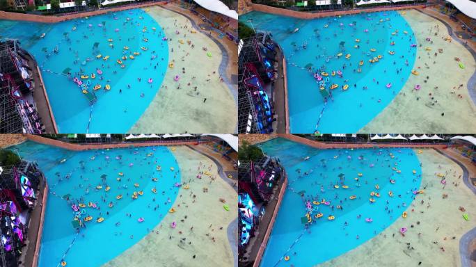 航拍夏天城市水上乐园游泳池的人群