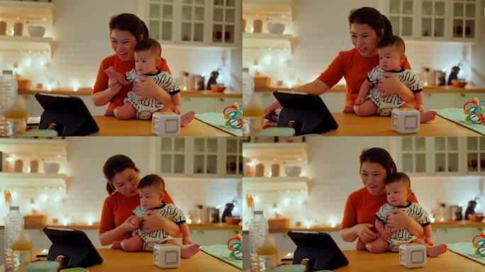 亚洲家庭关系纽带母亲视频电话会议在家里与婴儿工作多任务妈妈抱着男婴在厨房