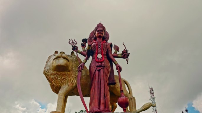 湿婆女神和金狮的高雕像。印度教的神圣代表。崇拜的人物。背景中的云景。