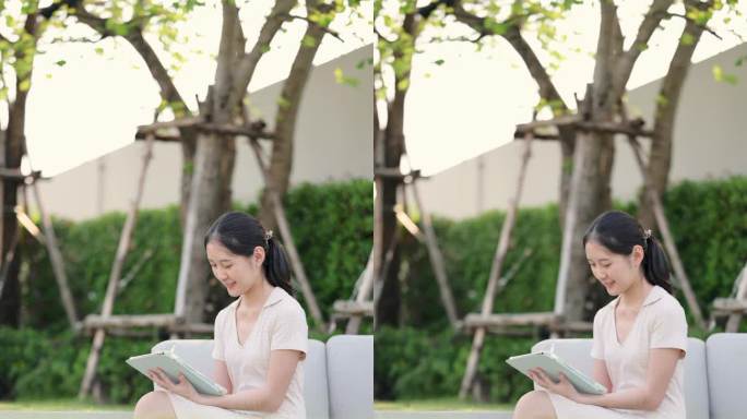 GenZ亚洲女性兴高采烈地坐在笔记本电脑前阅读有关她的股票投资新闻，在她的花园里投资