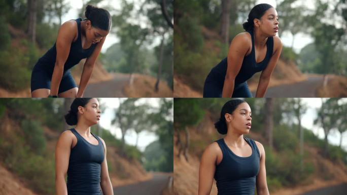 女性跑步者戴着耳机在街头跑步时停下来深呼吸并使用智能手表。运动与健康生活理念。