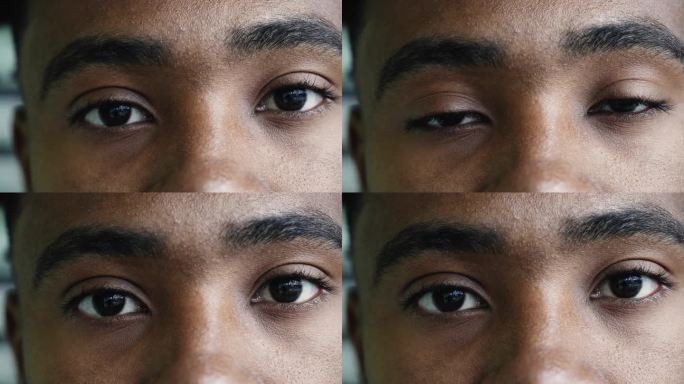 微距特写，一个年轻的黑人男子眼睛盯着镜头，眼神凝重，表情严肃严肃，眉目相视
