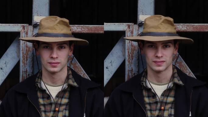 一个年轻的农民的肖像，带着自信的目光，戴着饱经风霜的帽子，穿着经典的格子衬衫在农村谷仓