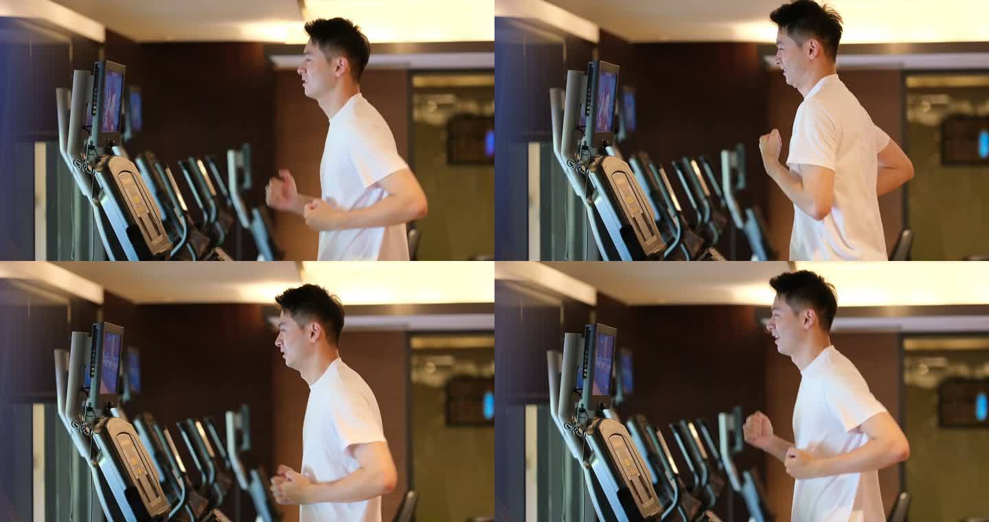 年轻男子在室内健身房的跑步机上跑步运动