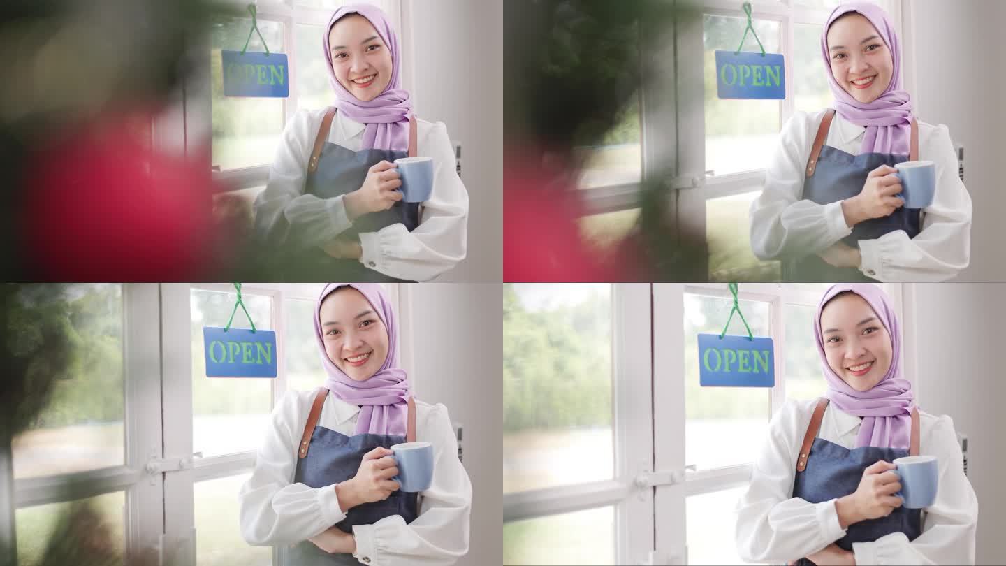 一个美丽的亚洲穆斯林妇女开咖啡店的肖像