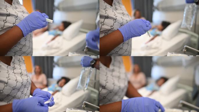 友好的非洲护士在病房的病床上给可爱的女孩手臂上打点滴