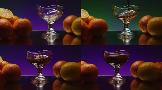 鸡尾酒杯:放在餐馆或酒吧柜台上的装有酒精鸡尾酒的杯子股票剪辑。用橘子装饰的吧台
