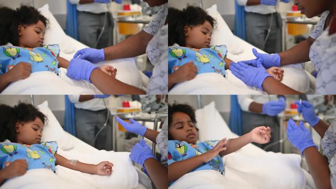 友好的非洲护士在病房的病床上给可爱的女孩手臂上打点滴