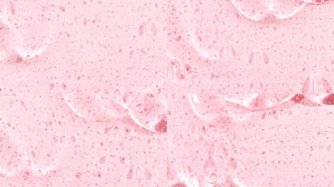 粉红色的化妆品凝胶流体与分子气泡流动在纯白色的背景。液体乳霜凝胶。天然有机化妆品、药品微距拍摄。生产