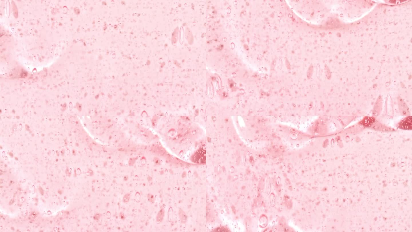 粉红色的化妆品凝胶流体与分子气泡流动在纯白色的背景。液体乳霜凝胶。天然有机化妆品、药品微距拍摄。生产