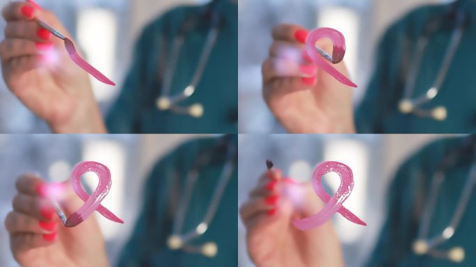医生在窗户上画了一个粉红色的乳腺癌标志。