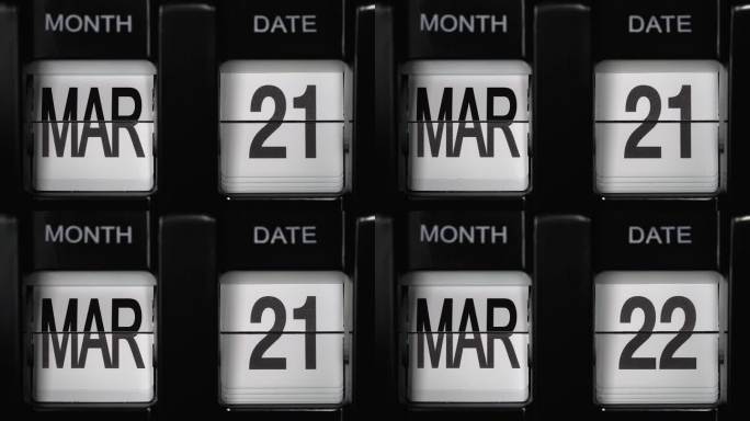 从3月21日到3月22日的日期变化的复古翻转日历。关闭了。