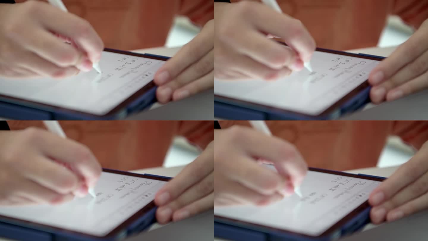 一个人在写字板上写字的手。做电子笔记