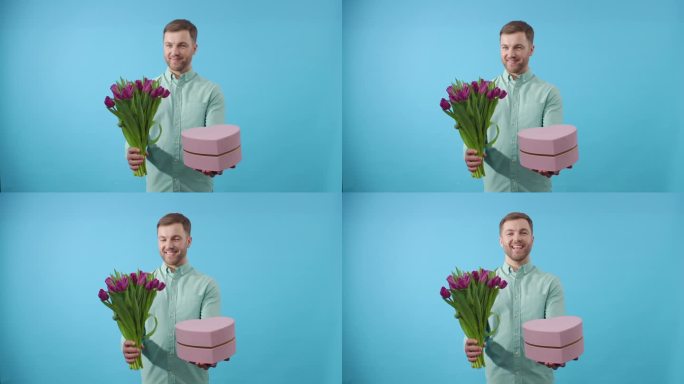 男子拿着粉红色的礼物和蓝色背景上的鲜花