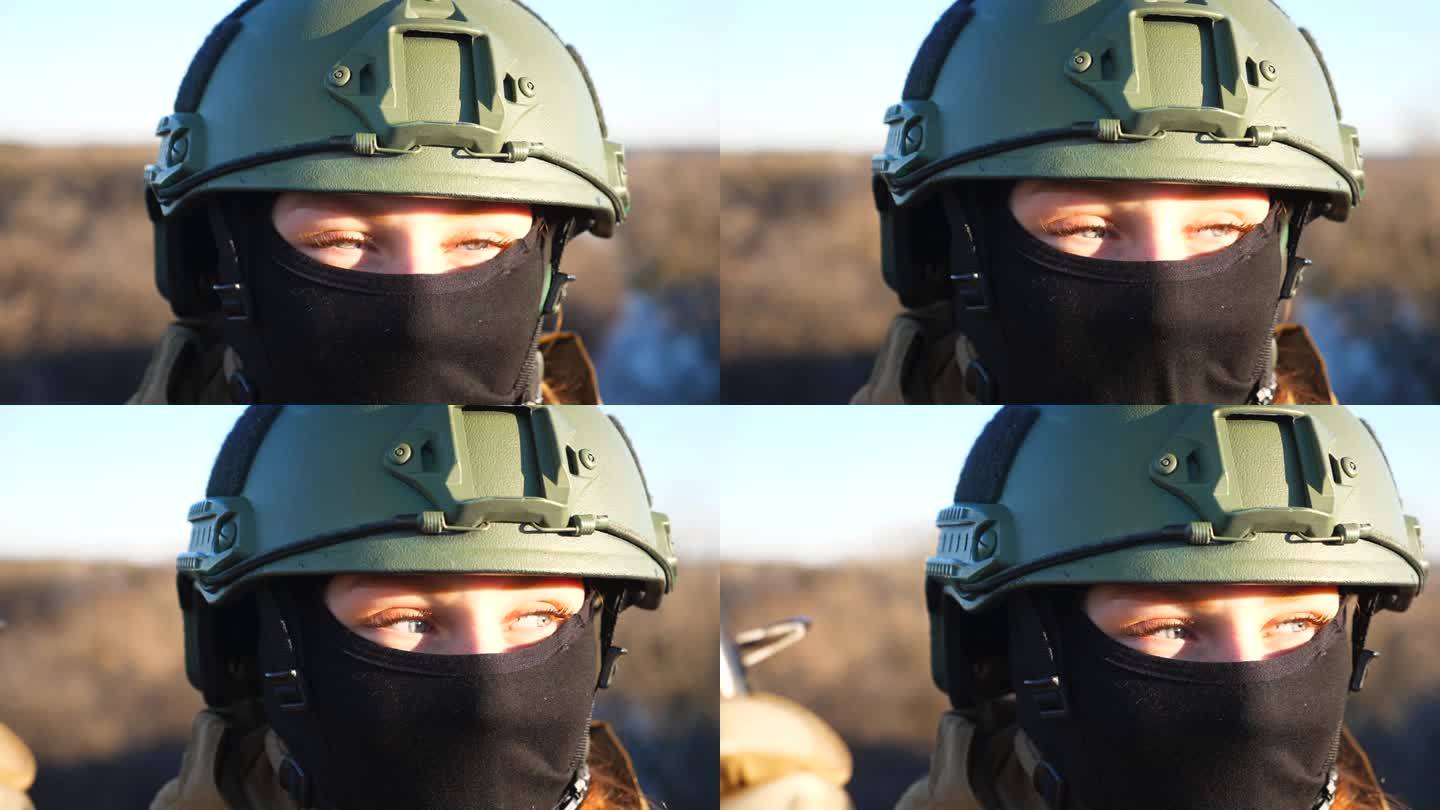 近距离看日落的年轻女军人的蓝眼睛。乌克兰女士兵头戴头盔，头戴巴拉克拉瓦帽。入侵乌克兰领土。欧洲战争结