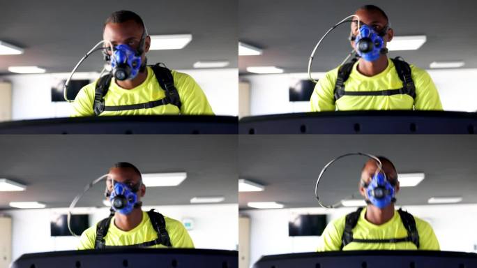 一名黑人运动员戴着所有的监测设备在跑步机上进行人体肺活量测定