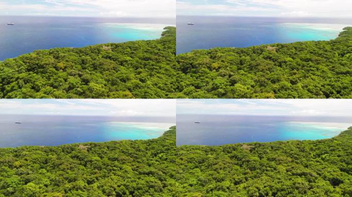 电影般的无人机在斐济的森林上空飞行，背景是游轮
