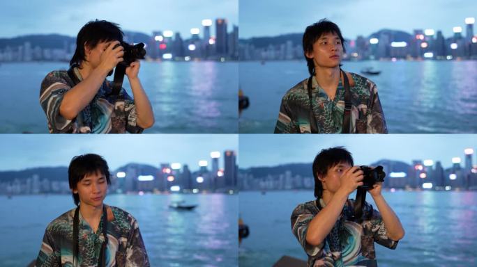 一名亚洲男子正在拍摄香港维多利亚港