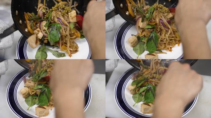厨师用锅铲把传统的豆腐垫从热气腾腾的煎锅里装到餐厅里，慢镜头近距离4K