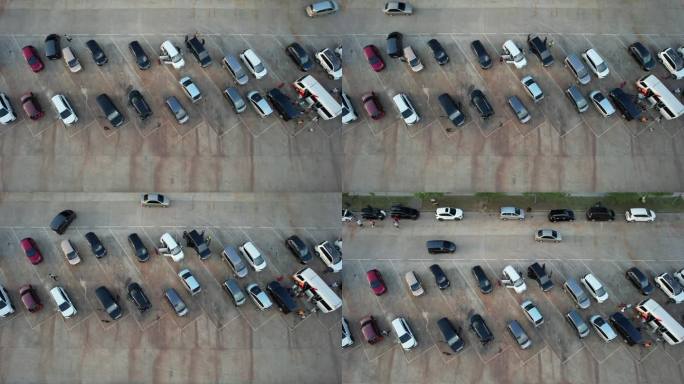空中录像停车场。人员和车辆的交通。汽车停得整齐有序。