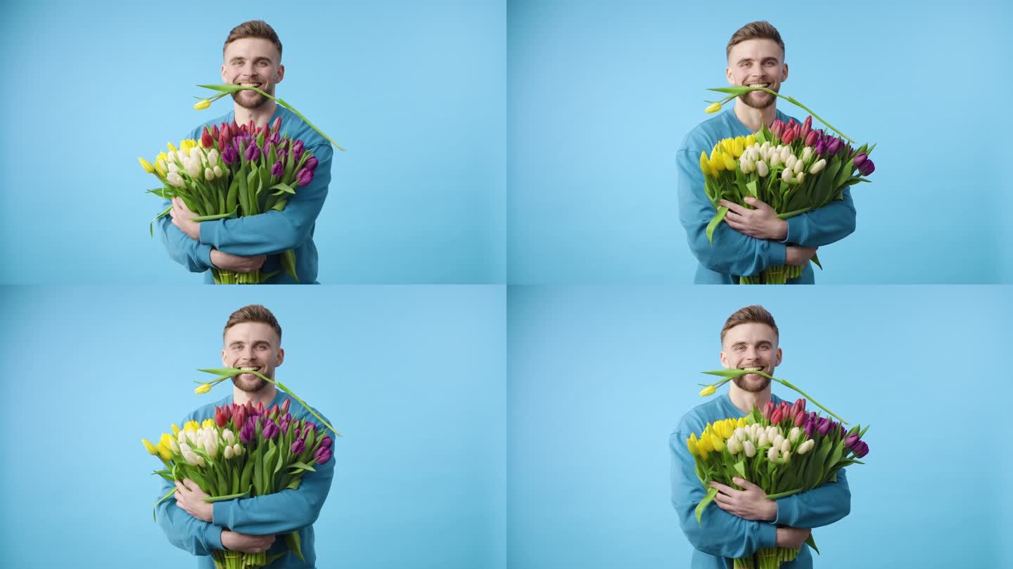 留着胡子的男人拿着一束蓝色背景的花