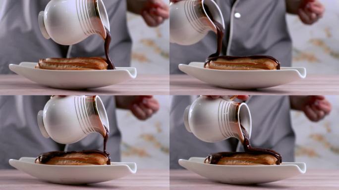 厨师在泡芙上涂上了巧克力奶油。用巧克力奶油装饰泡芙