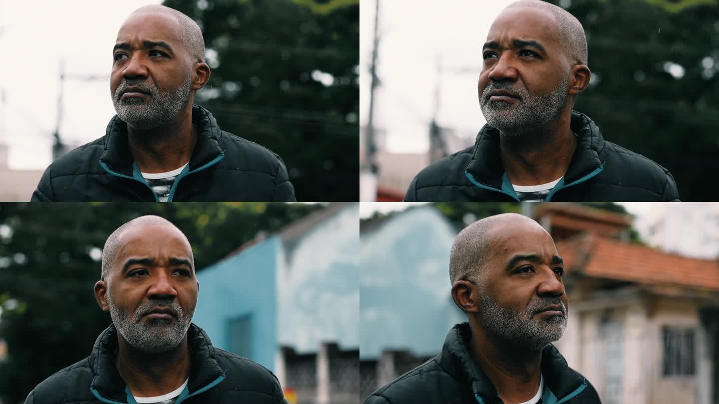 一个强硬粗暴的中年南美黑人走在城市街道上，一个50多岁的非洲裔人的特写脸，凝视着沉思