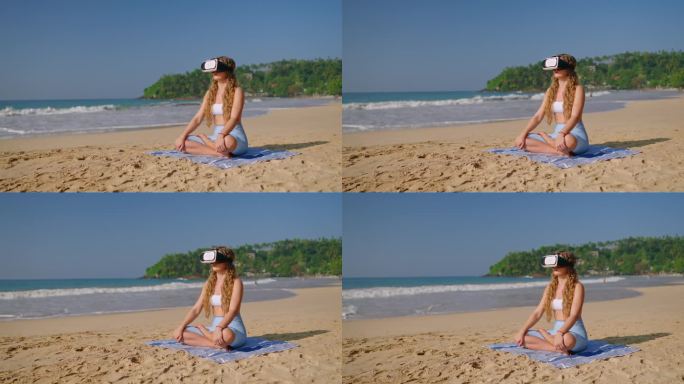 戴着VR头显的女人盘腿坐在沙滩上，体验虚拟冥想，海浪抚摸海岸，沉浸式放松，日出倒映水面，科技满足宁静